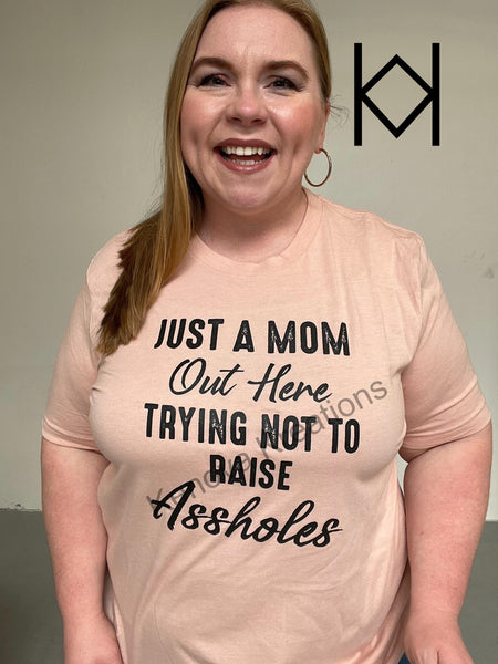 Just a Mom Trying Not to Raise Assholes Tee